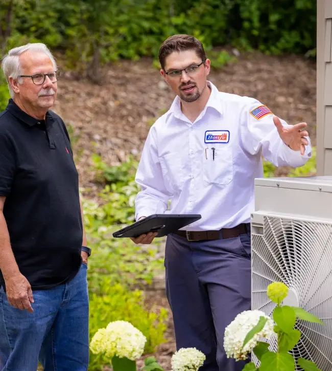 Bonfe HVAC Tech explaining options to a home owner