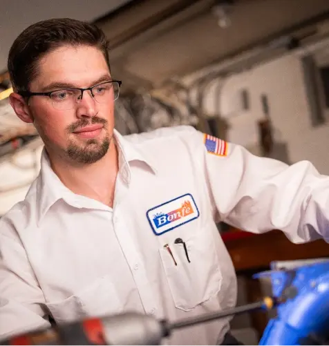 Service Tech from Bonfe inspecting Heating services